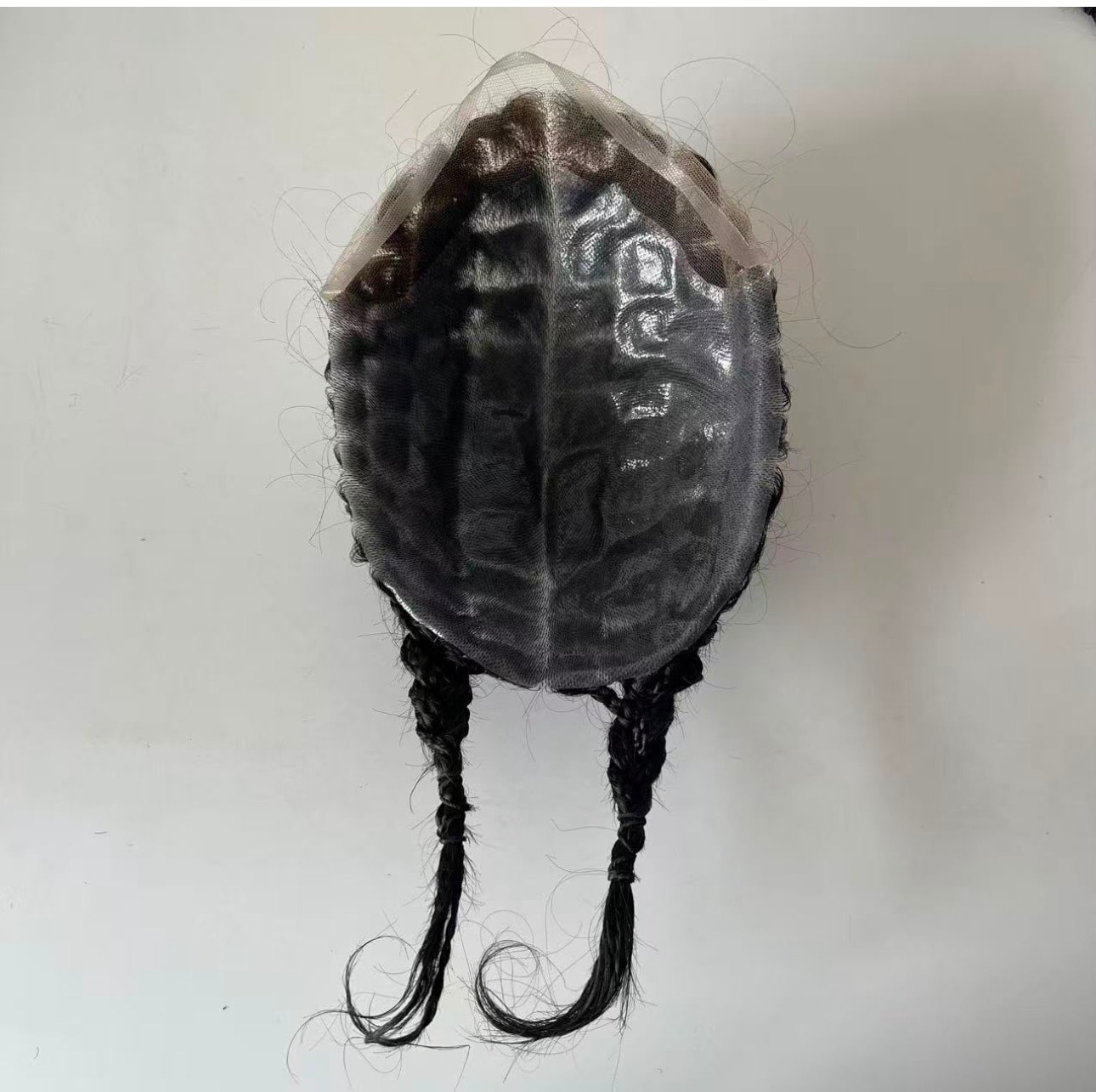 OMB Braided Hair System — underside view showing full lace base construction with braided tails